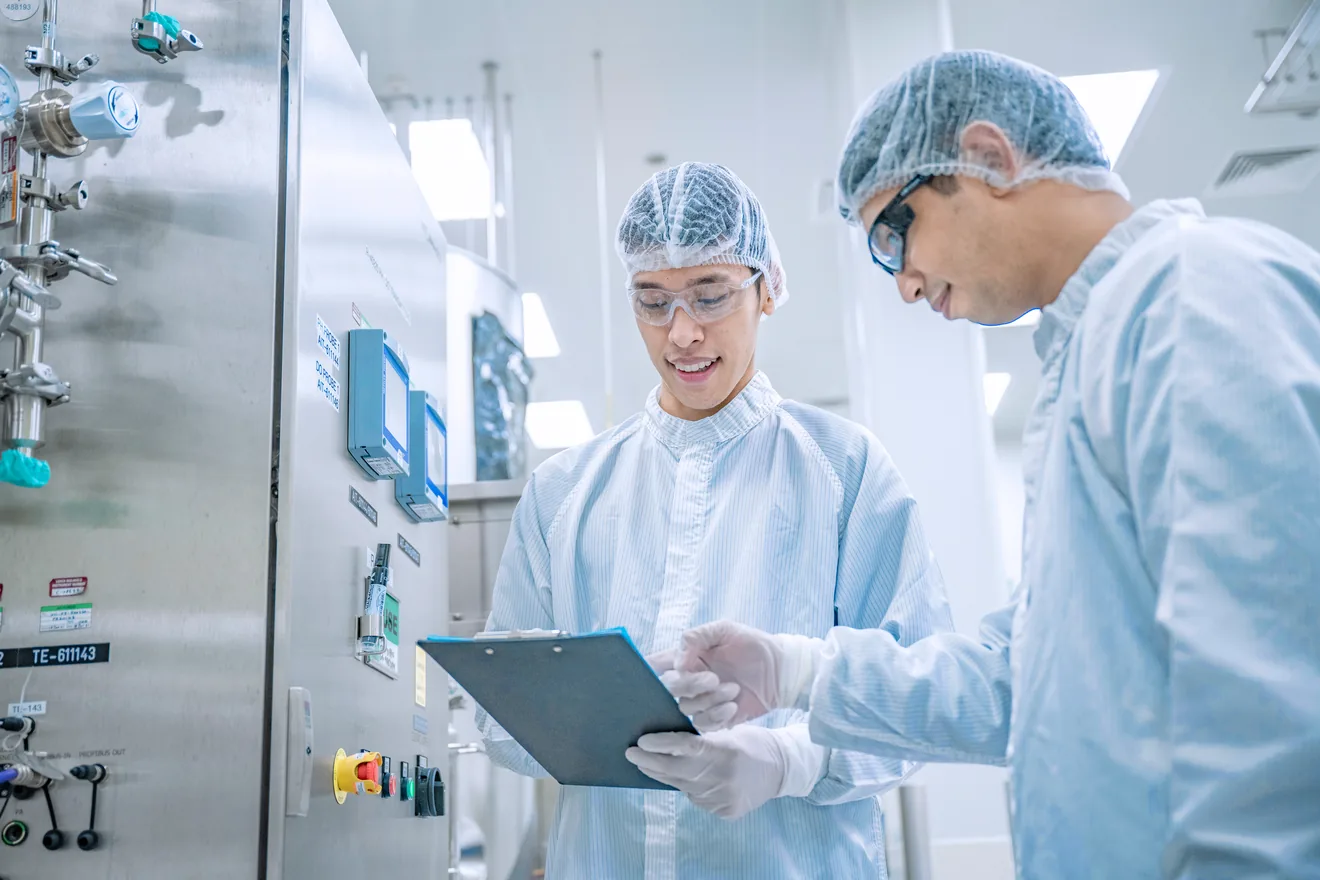 two lab techs reviewing paperwork 
