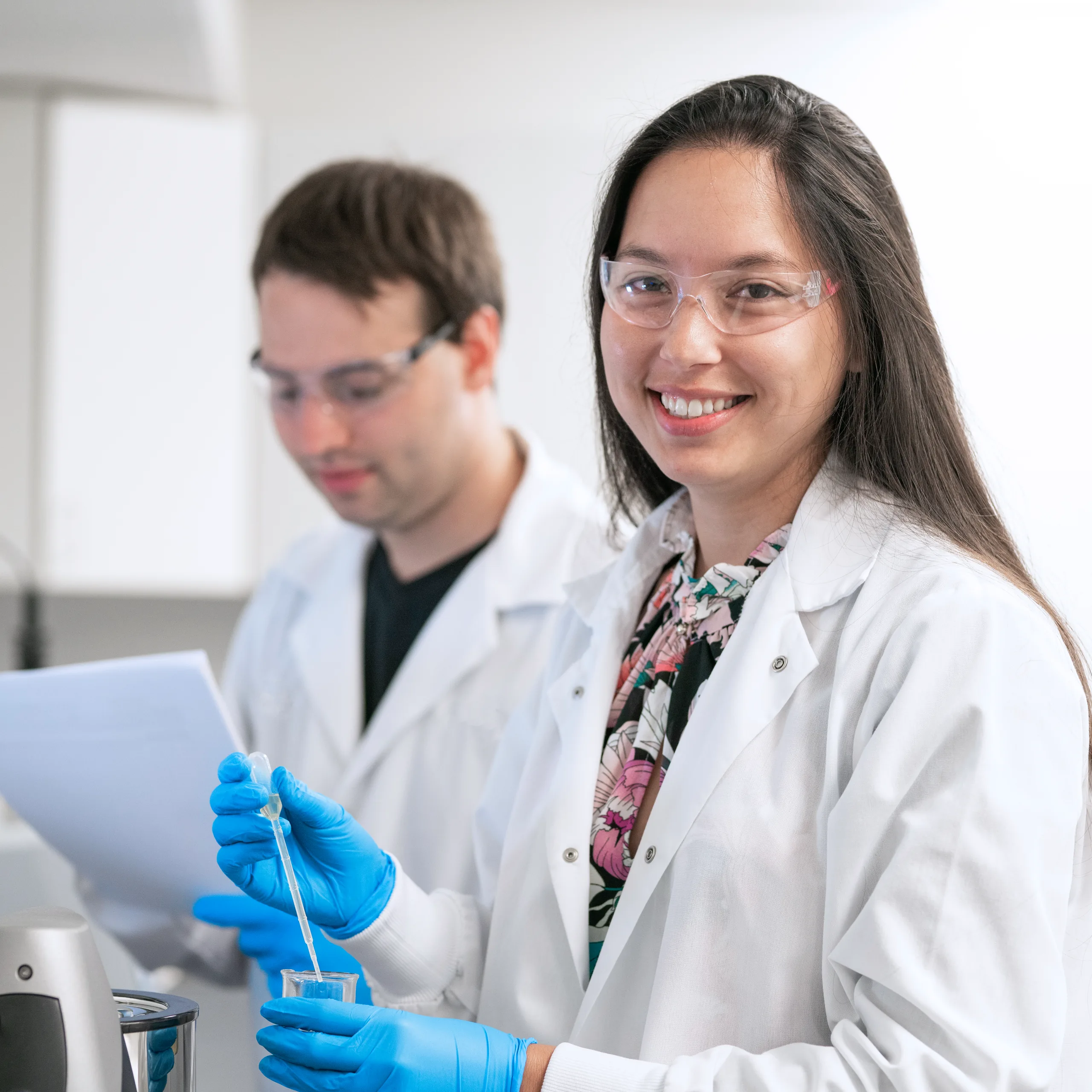  Woman smiling taking a sample with test tube
