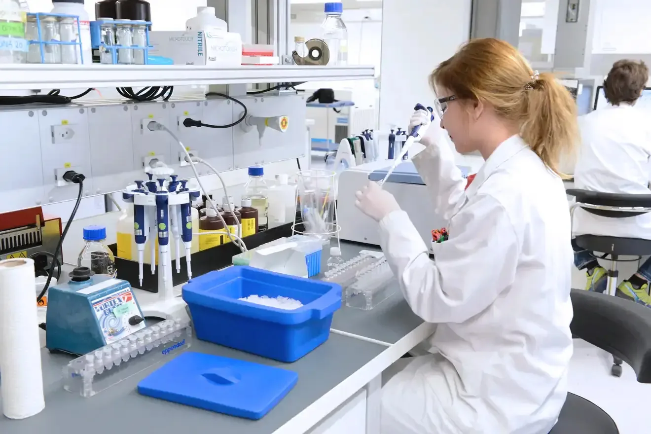 Woman work in lab - rebrand